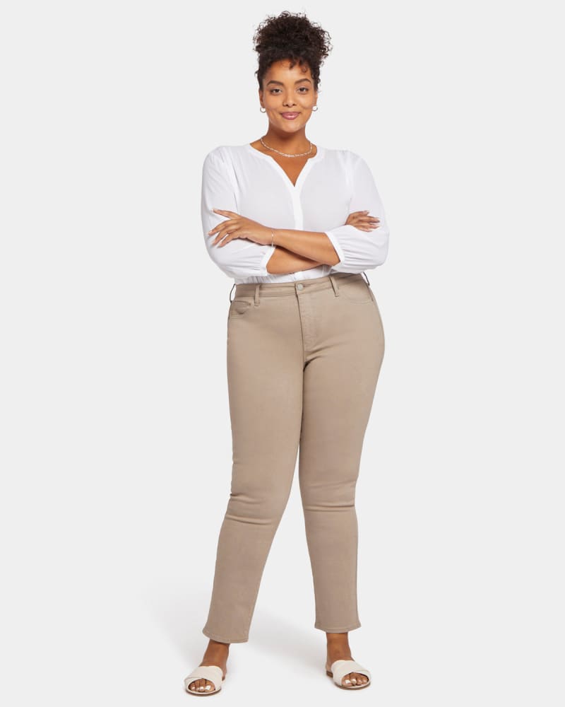 Front of a model wearing a size 14W Sheri Slim Leg Jean in Saddlewood by NYDJ. | dia_product_style_image_id:296184